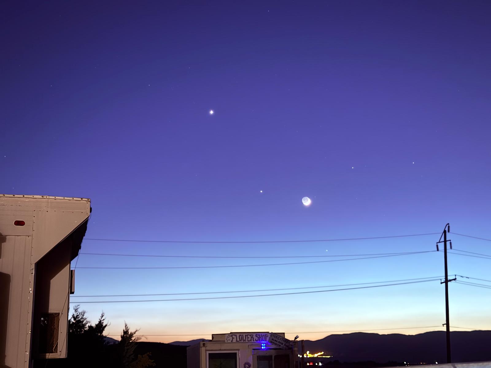 The moon and stars in a violet sky over Hikertown at nightfall