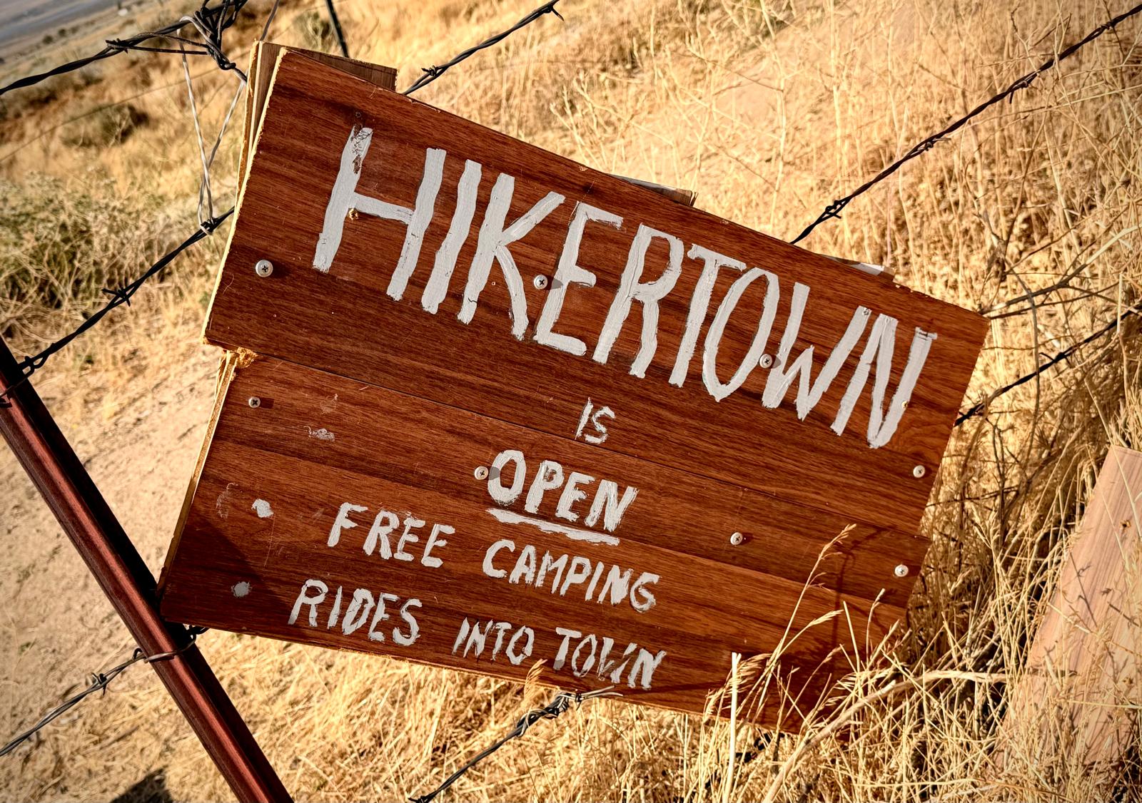 The hand-painted Hikertown sign on a barbed-wire fence