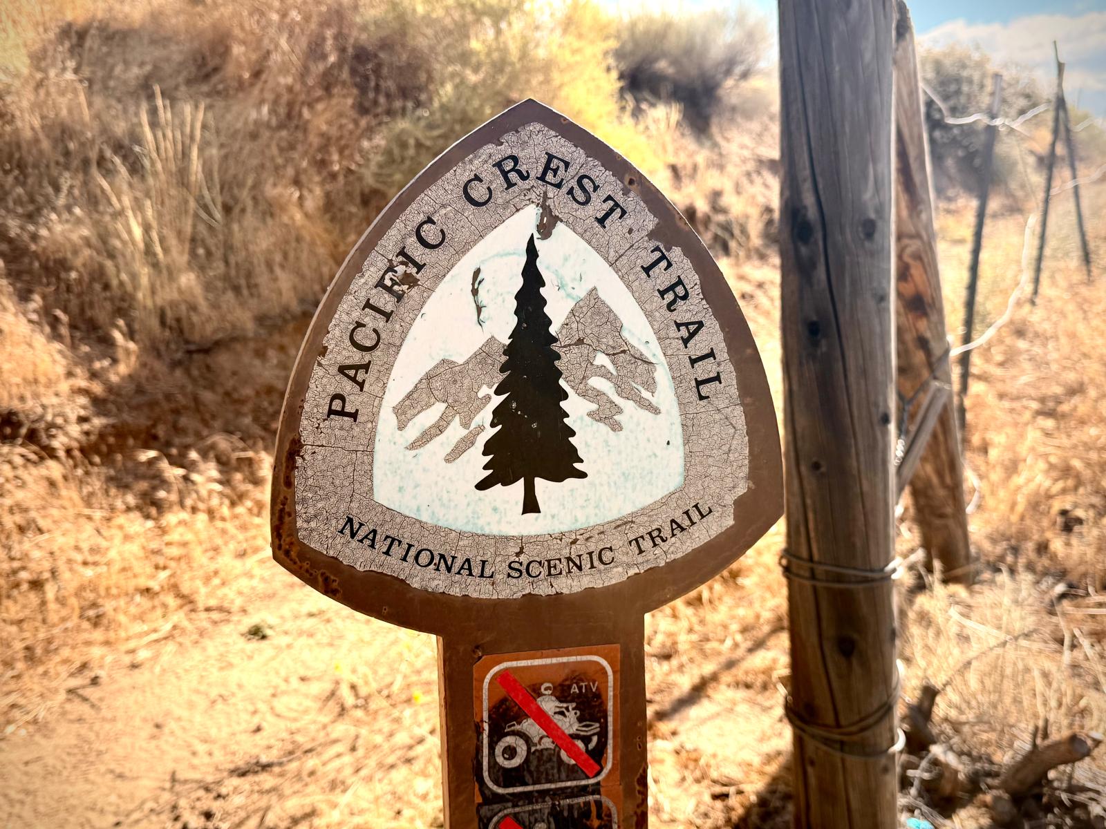A weathered Pacific Crest Trail marker on the Mojave stretch of the route