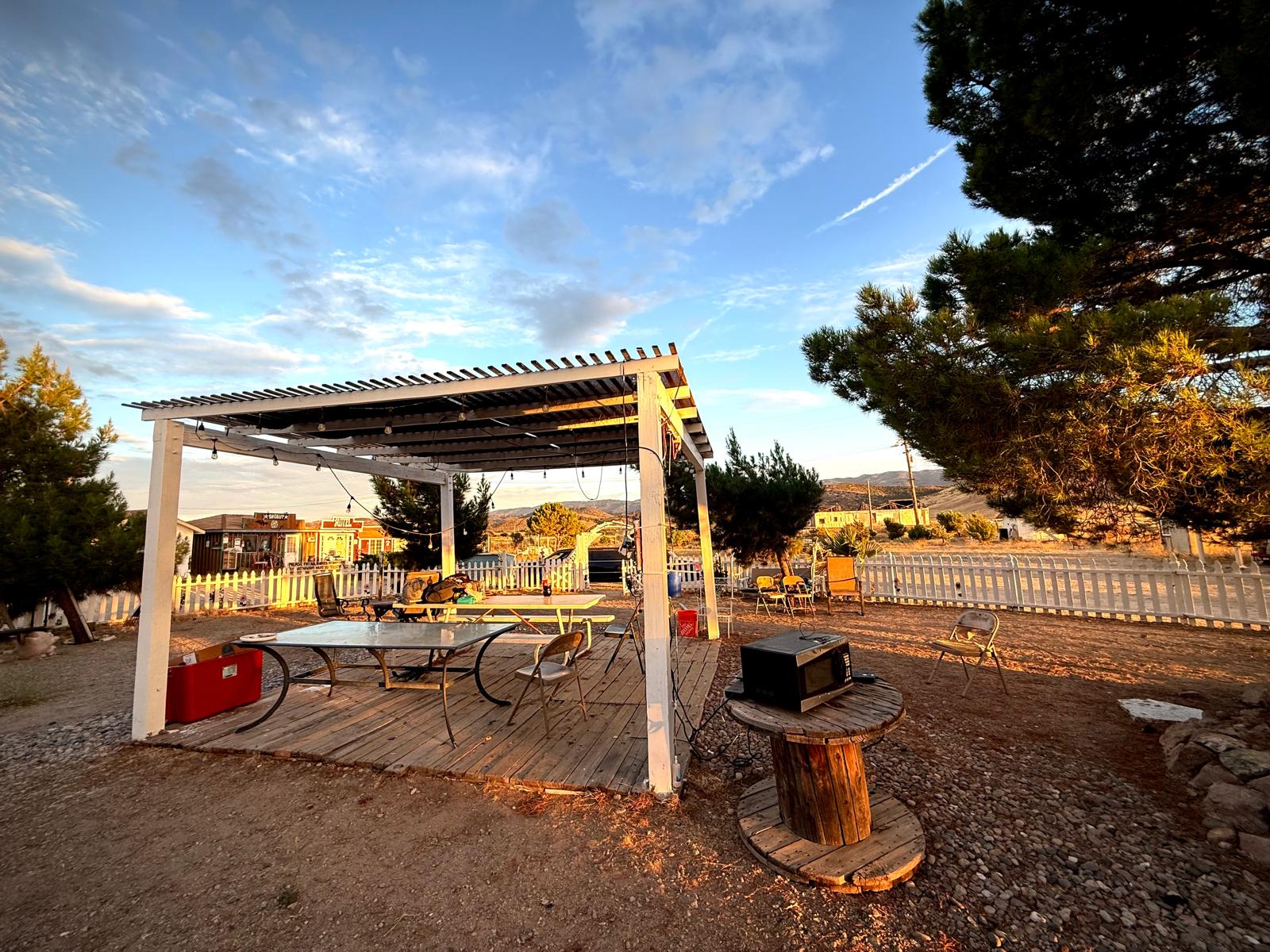 The covered deck and picnic tables where hikers gather, town behind